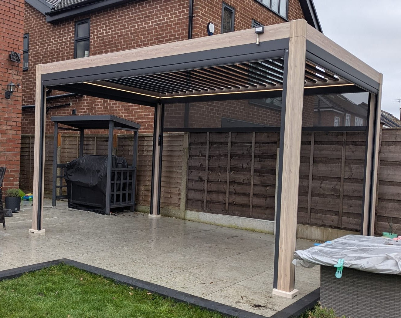 LuxShade™ 3×4m Oak Effect Aluminium Pergola with LEDs, Double-Layered Louvres