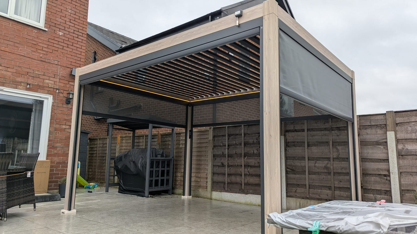 LuxShade™ 3×4m Aluminium Pergola – LEDs, Double-Layer Louvres & 3 Windscreens - Oak Effect