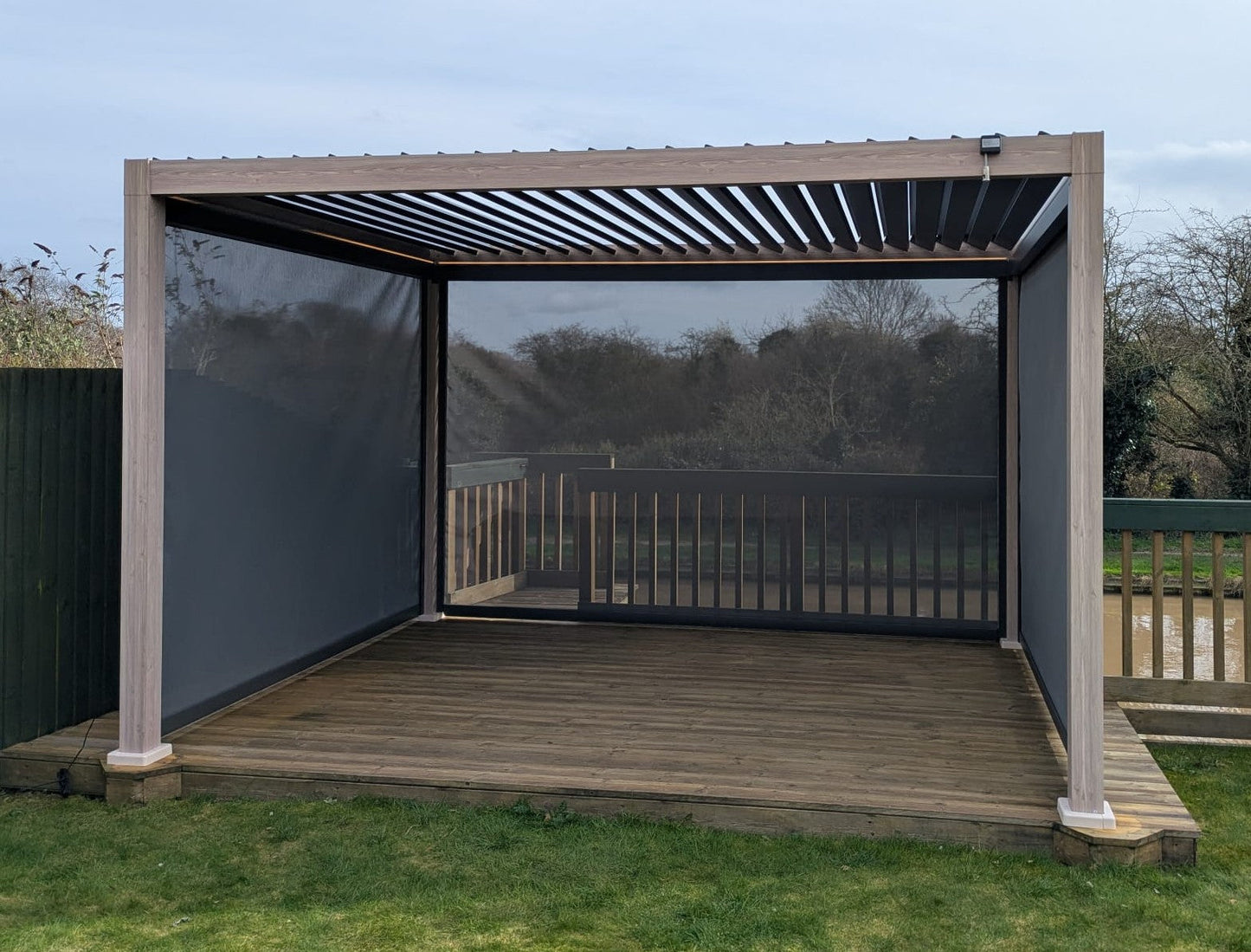 LuxShade™ 3×4m Aluminium Pergola – LEDs, Double-Layer Louvres & 3 Windscreens - Oak Effect